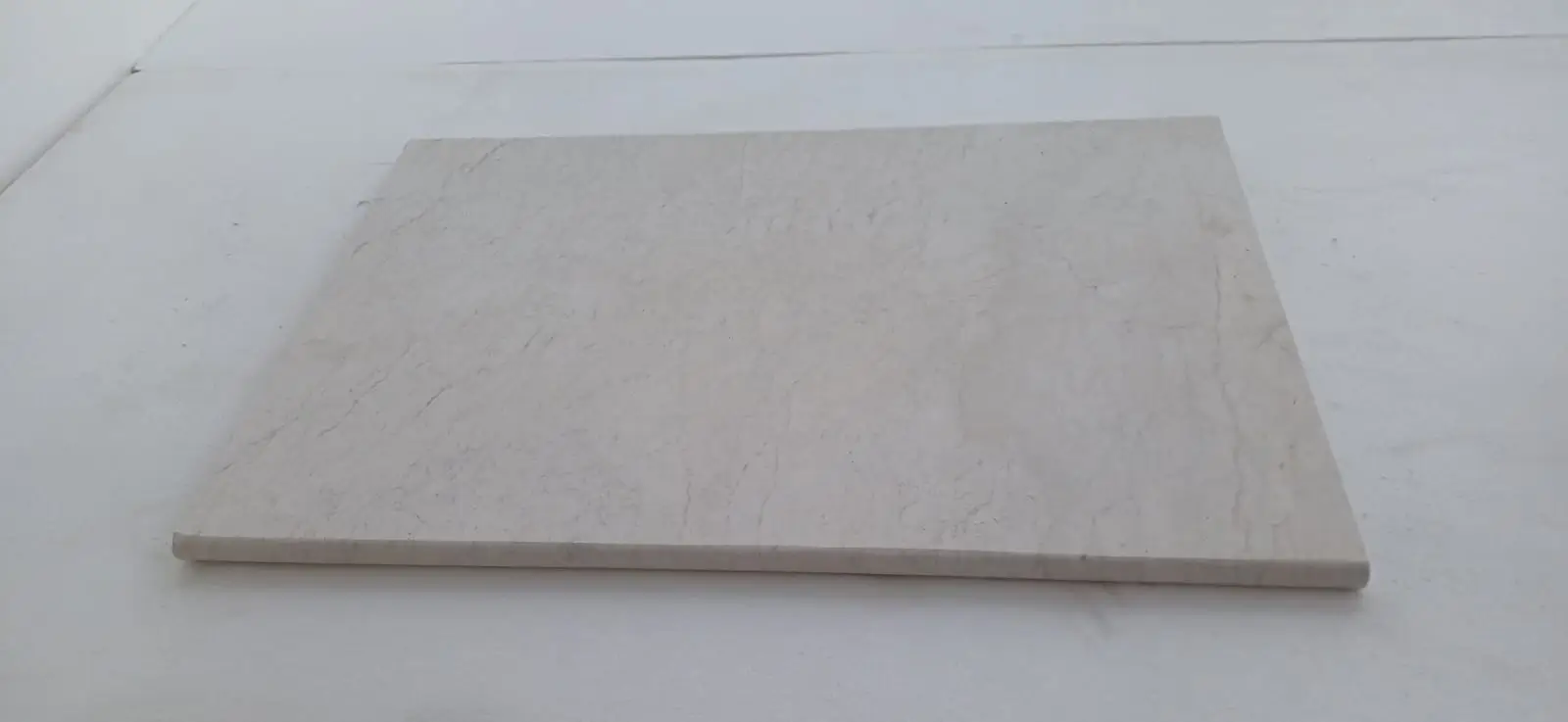 A pale beige marble slab displays subtle veining on its smooth surface, pictured for decomposed vs crushed granite.