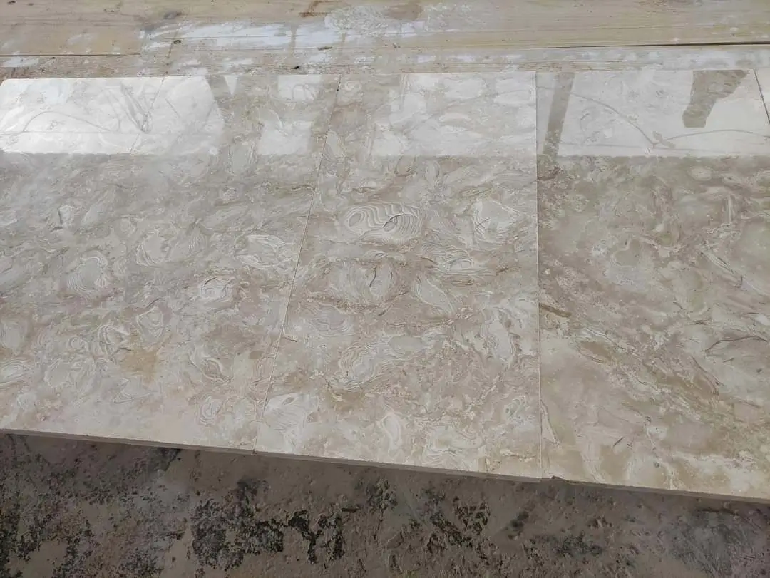 Polished marble slabs display intricate veining and swirling patterns in a natural stone finish, an example for how to clean ivory travertine.