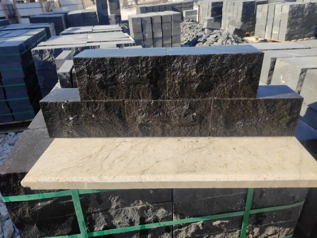 Stacked dark granite pavers with a light marble slab on top, a reference for rectangle stone pavers.