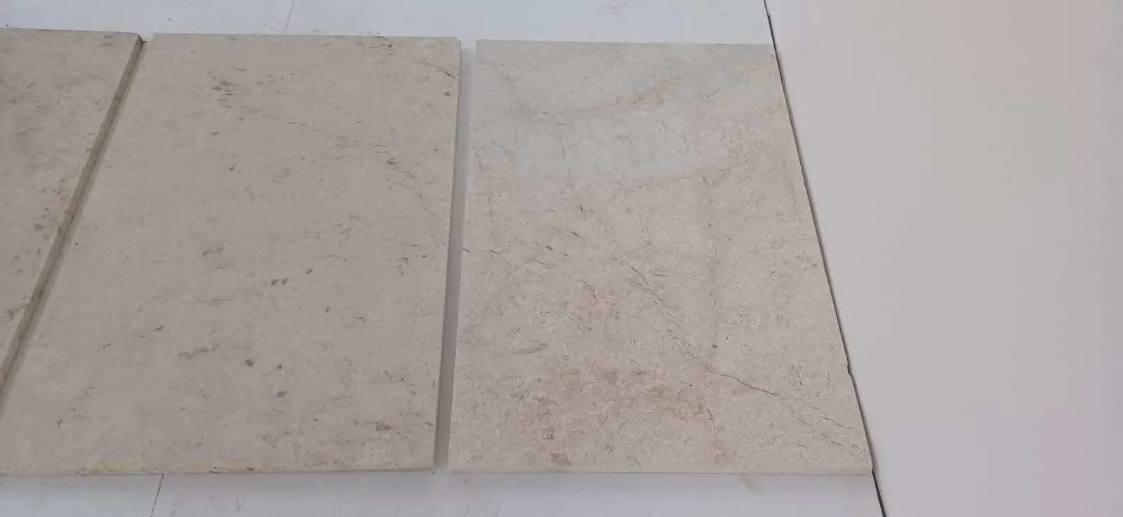 Close-up surface texture of beige limestone tiles showing natural variation, relevant to granite density explained.