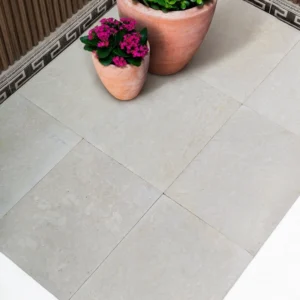 Bianco Velo brushed white limestone tile with a soft ivory veil across a pearl-white ground