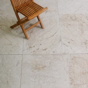 Coarse brushed cream limestone with brown veining in deep matte texture