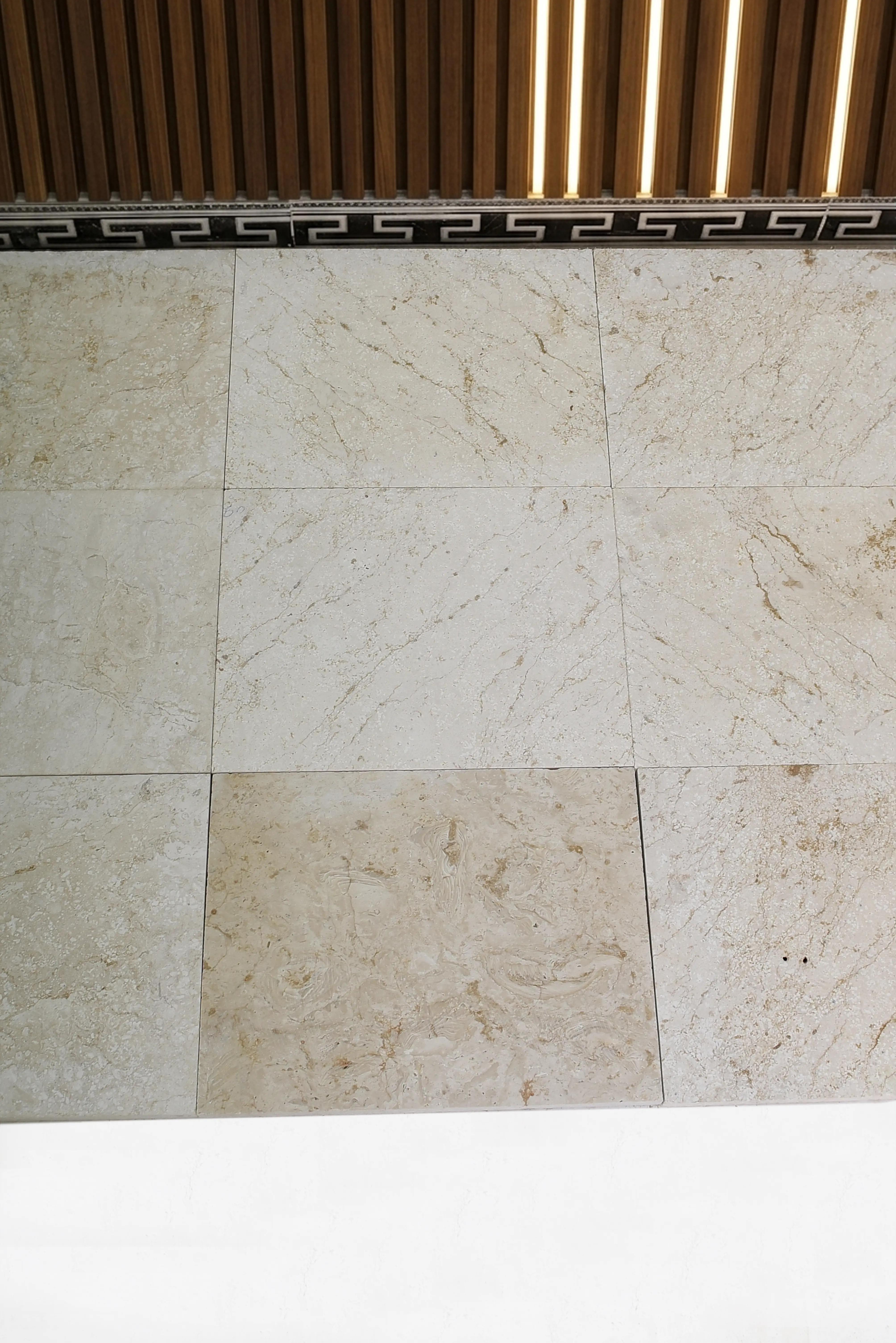 Beige Marble Tile Wall and Ceiling Detail Close-up texture of beige marble tiles with natural veining for modern wall applications, pictured for paving stones driveway cost.