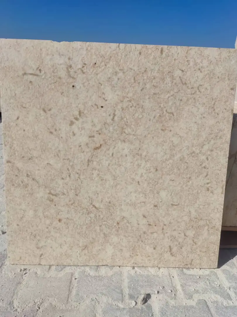 Creamy beige limestone slab featuring subtle natural speckles and variations, a reference for granite landscape rock color comparison.