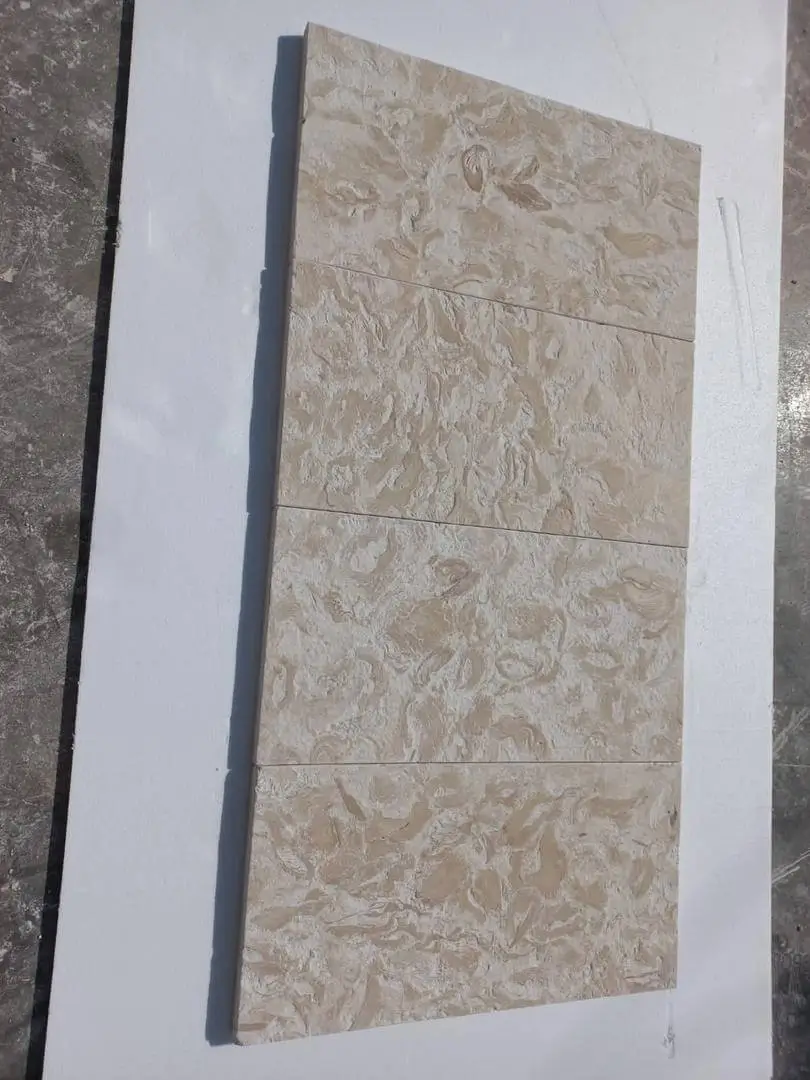 Close-up of beige limestone tile surface showing unique natural fossil patterns, pictured for natural limestone pool surfaces.