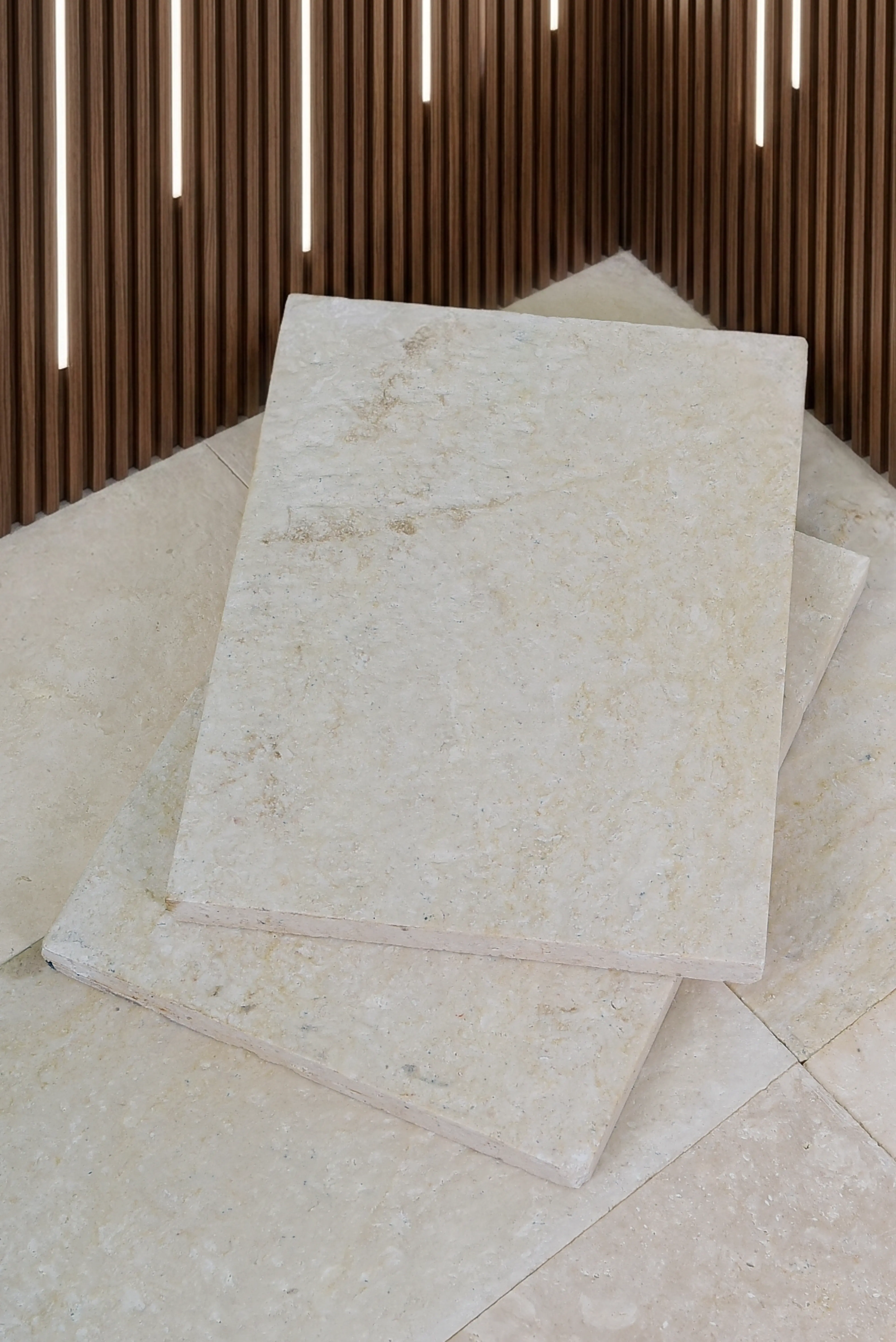 Beige travertine tiles display warm earthy tones and natural veining patterns, relevant to slab vs precast stone steps.