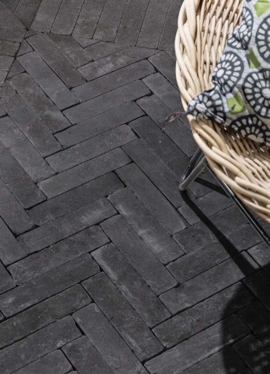 Black Basalt Setts in Herringbone Patio Brushed black basalt cobblestone setts laid in a herringbone patio pattern, relevant to cobblestone pavers.