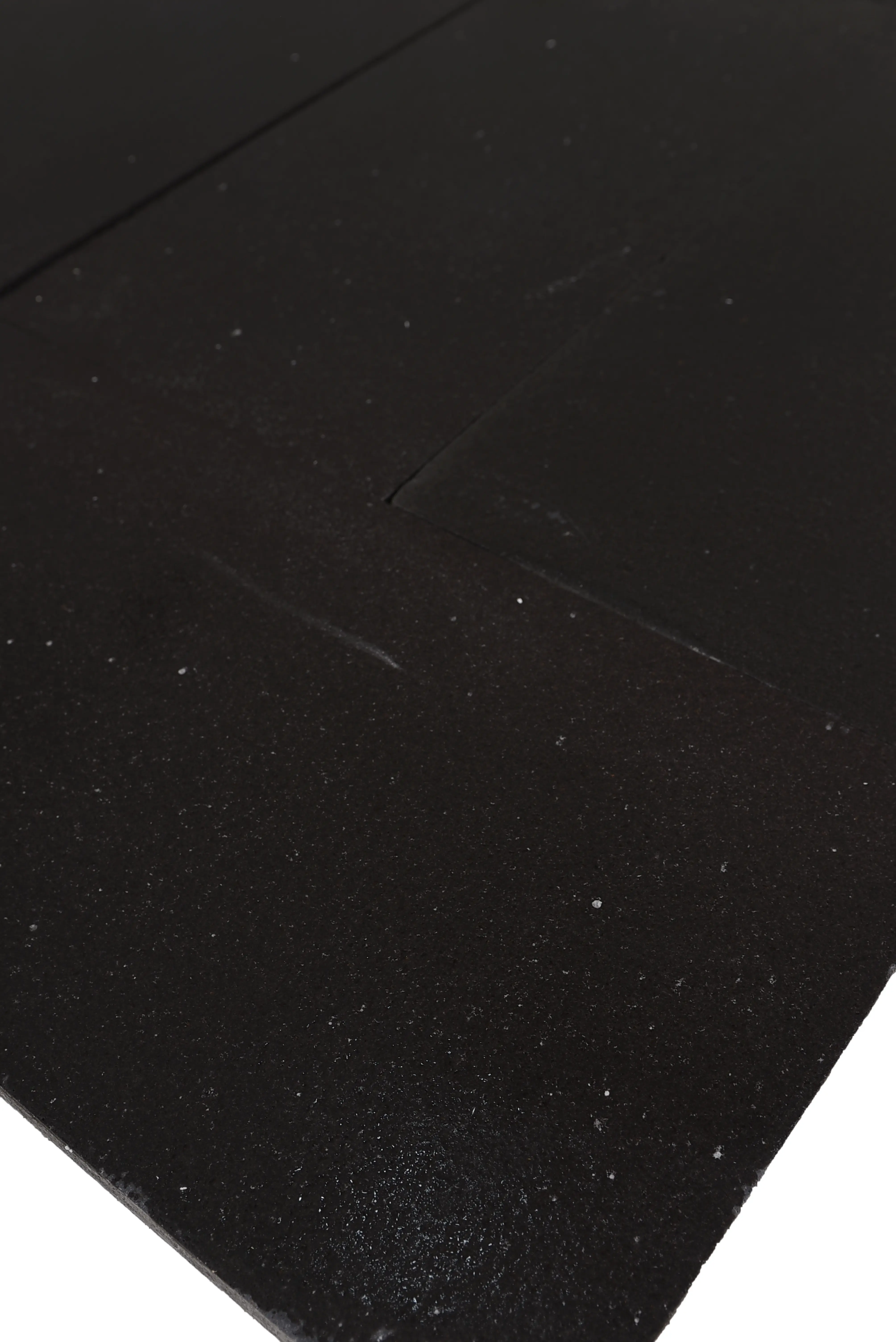 Dark textured surface detail for black basalt pavers with subtle reflective particles, an example for how to choose granite installers.