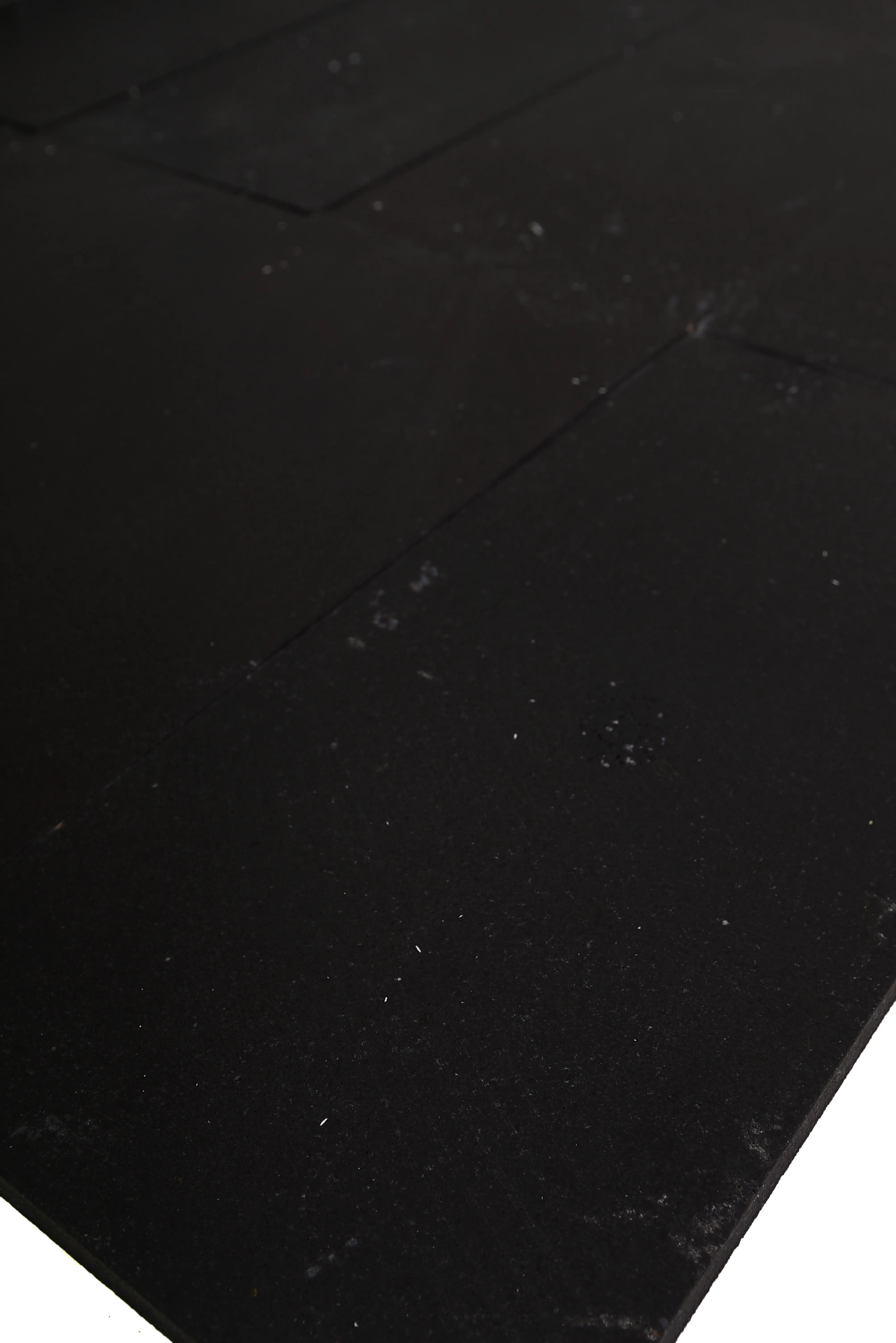 Close-up of a dark, textured surface, possibly part of granite pavers, shown for pavers with black border ideas.