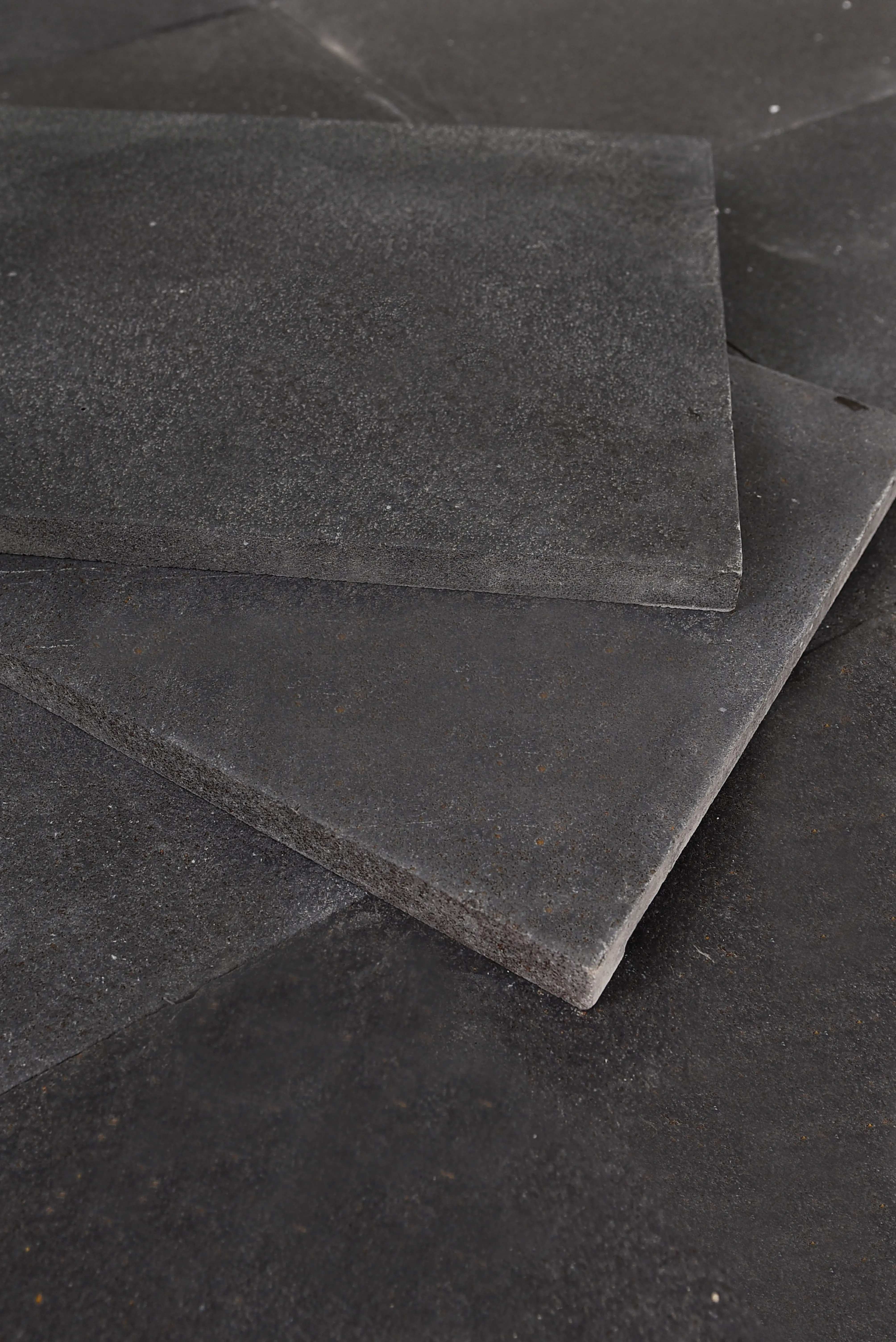 Close-up texture of dark grey slate stone slabs for paving and architectural use, shown for blue stone pavers for sale.