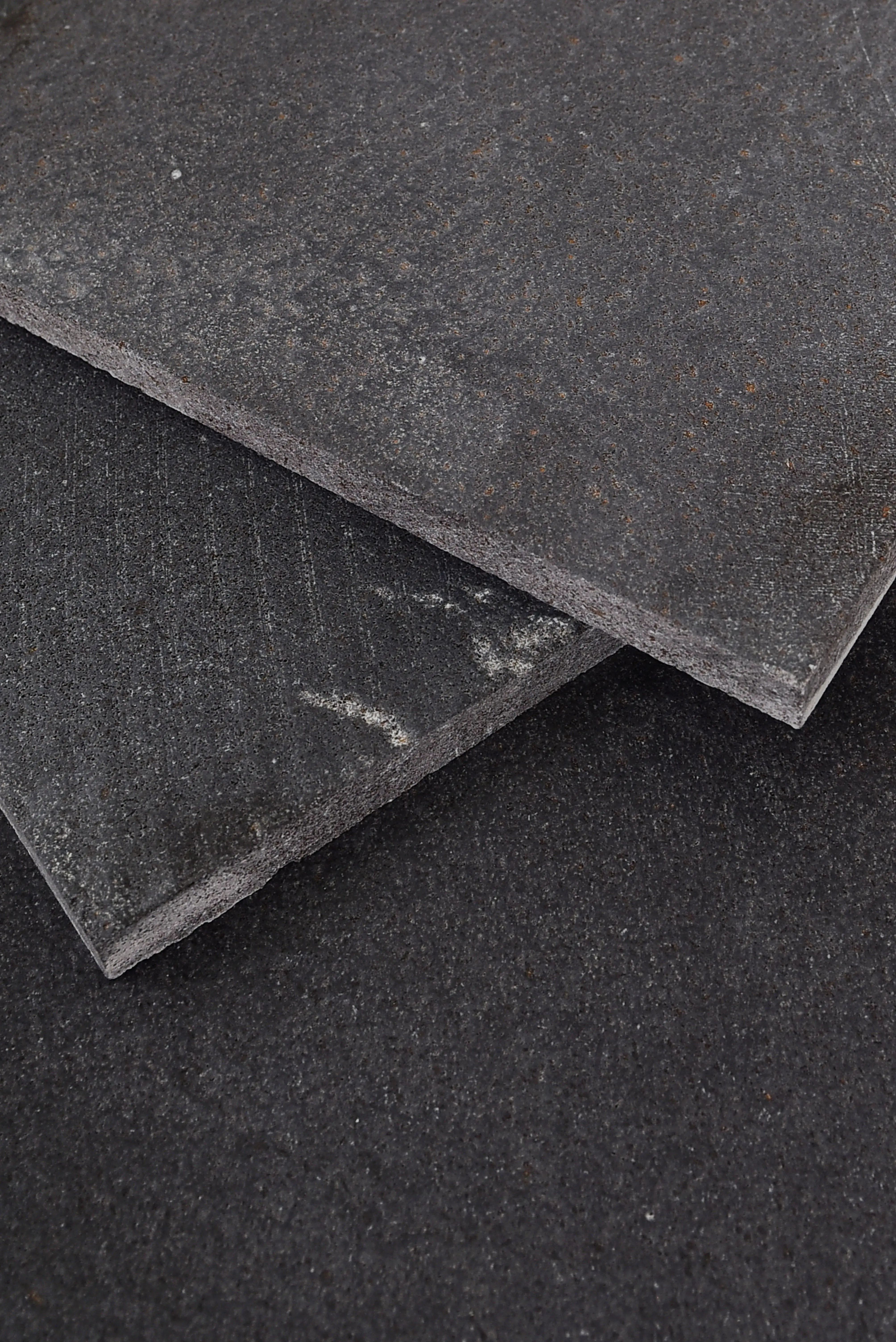 Dark Textured Stone Slabs Close-up of dark limestone stone slabs with textured surfaces and subtle variations, an example for limestone quarry blue pavers.
