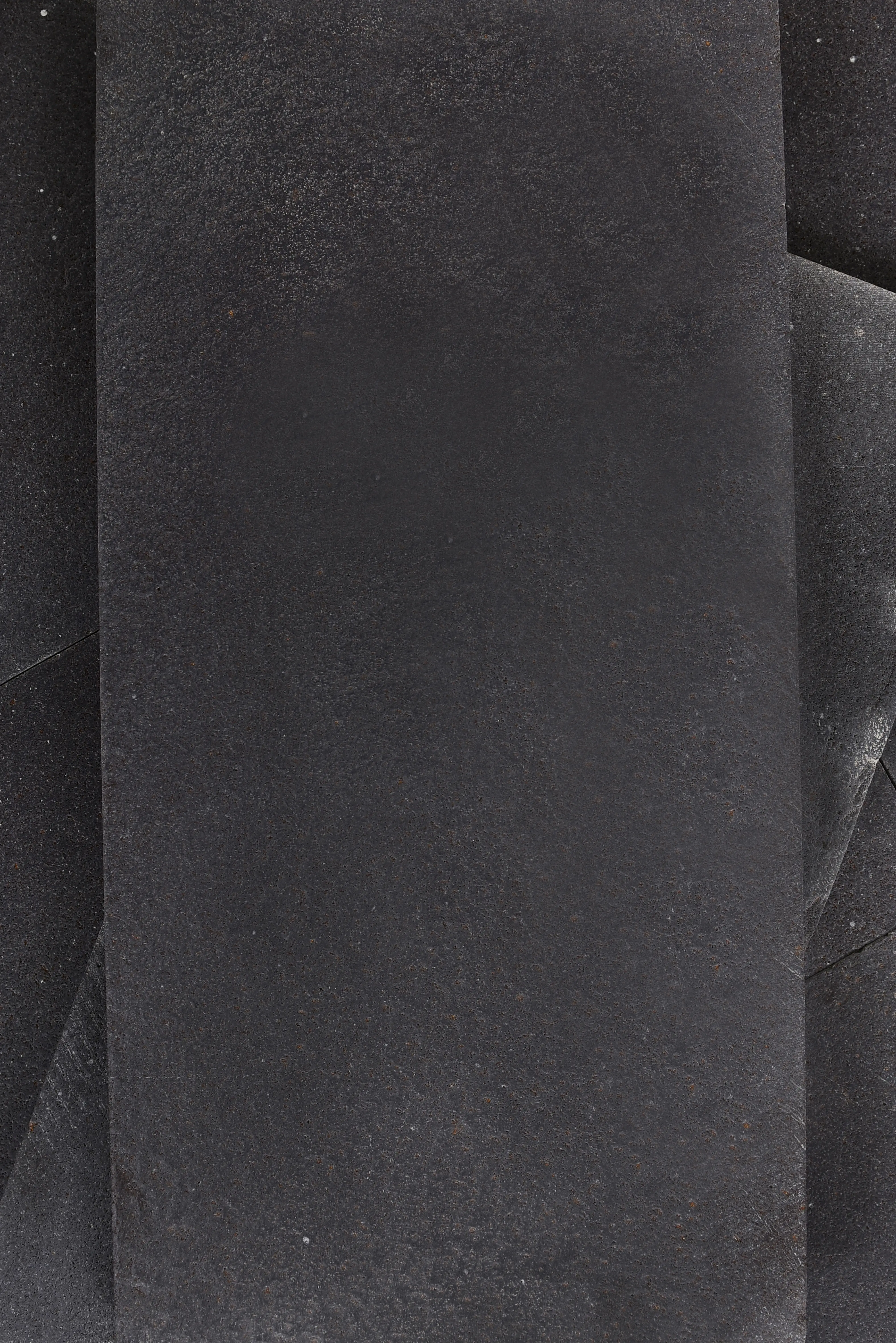 Dark Textured Stone Surface Overlap Close-up view of dark bluestone tiles creating a layered textured surface, an example for belgian bluestone slab.