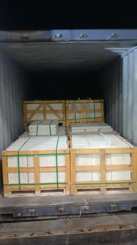 Delivery truck transporting secured crates of wholesale granite countertops materials for distribution.