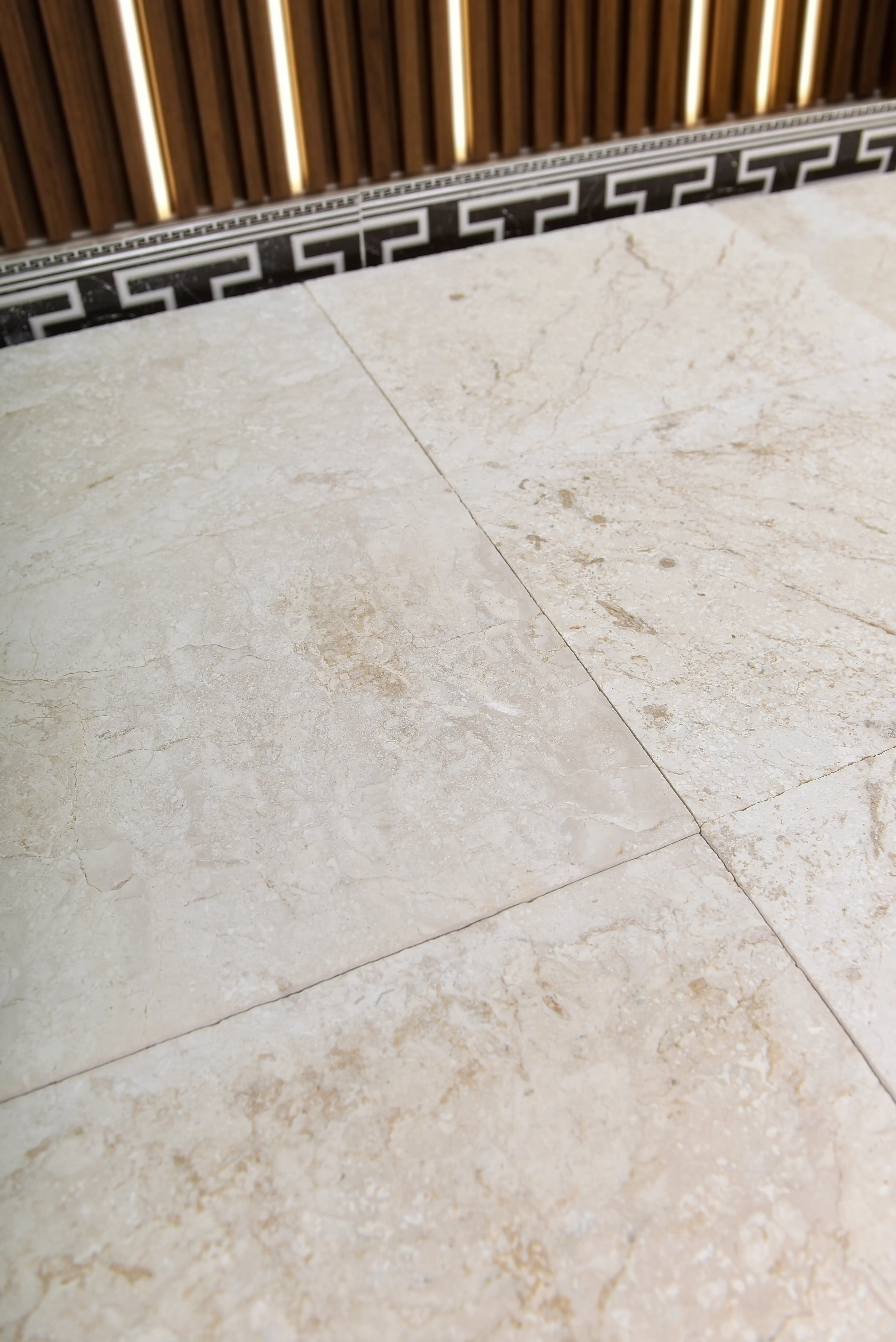 Light beige marble floor tiles showing subtle veining and texture