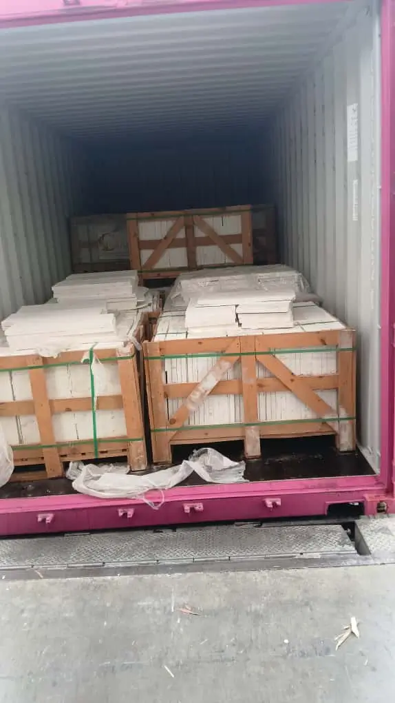 Delivery truck loaded with secured natural stone paving guide material crates ready for transport.