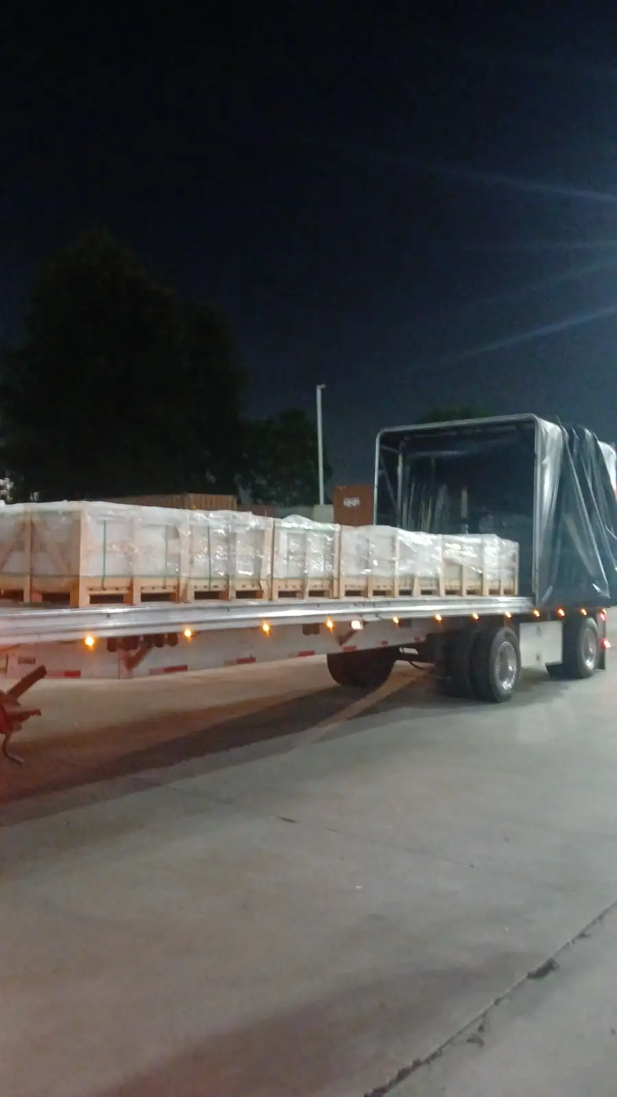 Delivery truck loaded with secured natural stone steps cost material crates ready for transport.