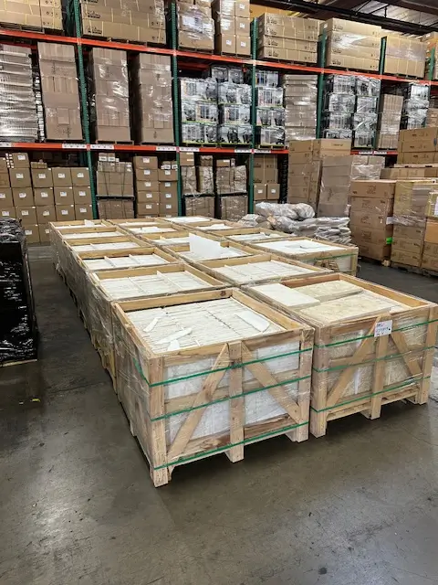 Distribution facility warehouse stores limestone for steps in heavy-duty crates.