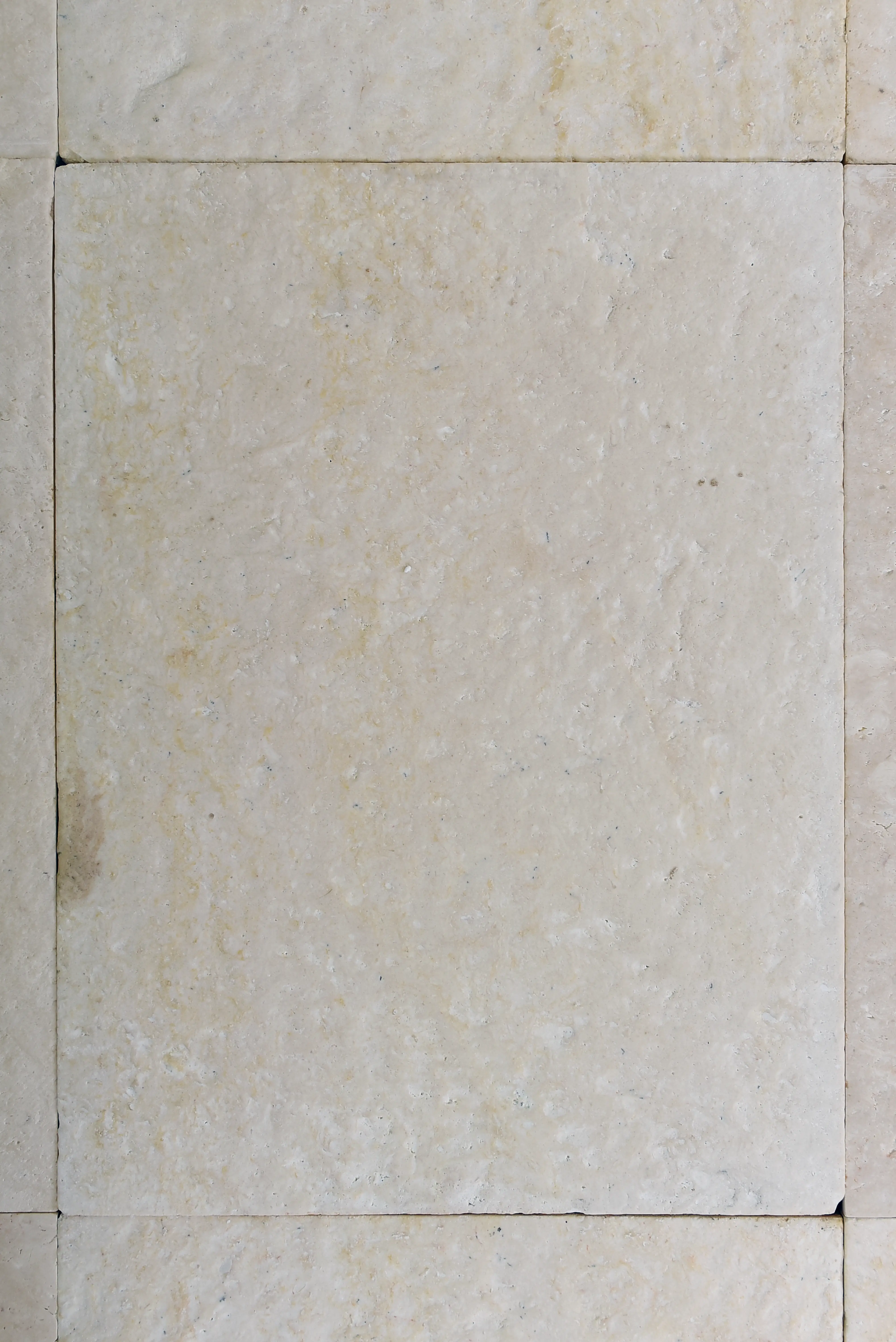 Neutral Stone Tile Texture Close-up of light beige limestone tiles showing natural texture and subtle veining, a reference for outdoor stone steps ideas.