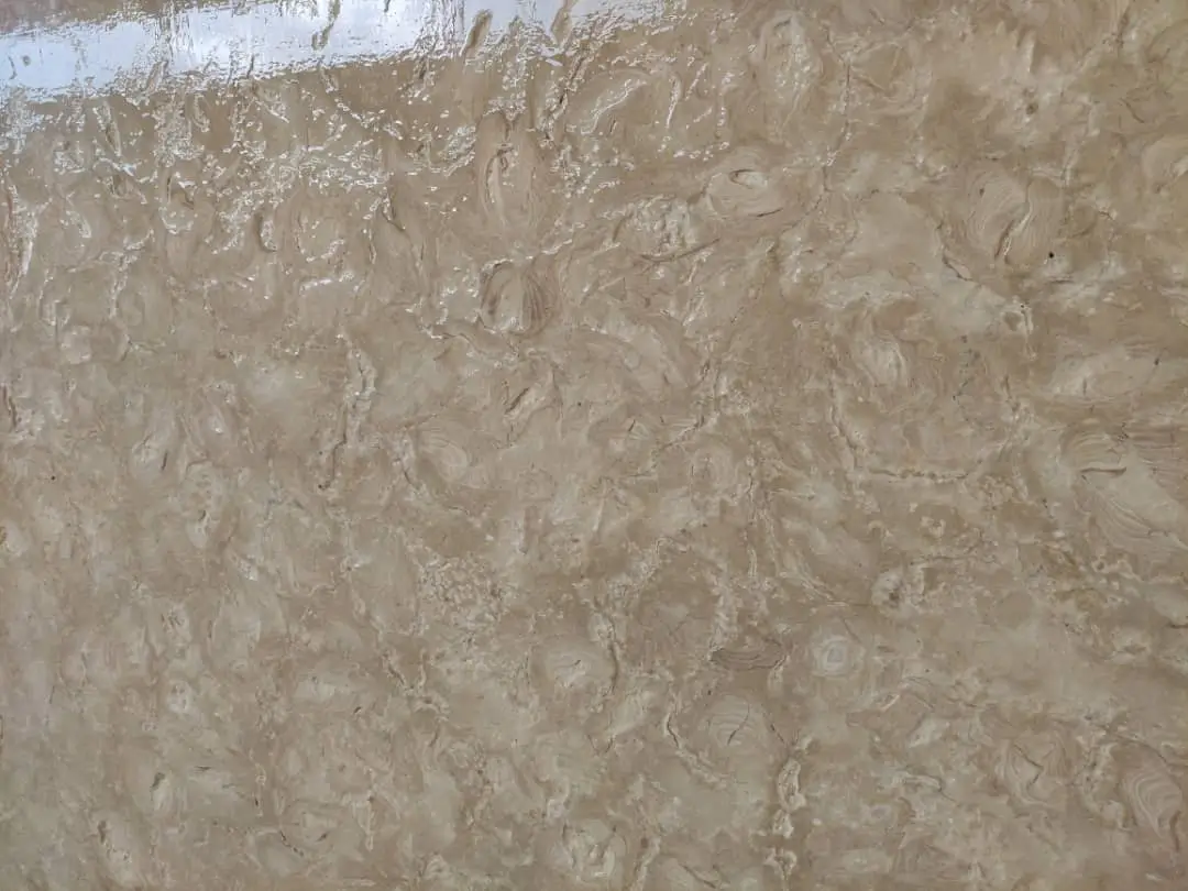 Close-up of polished beige travertine stone with wavy patterns and subtle veins, relevant to stone landscape steps.