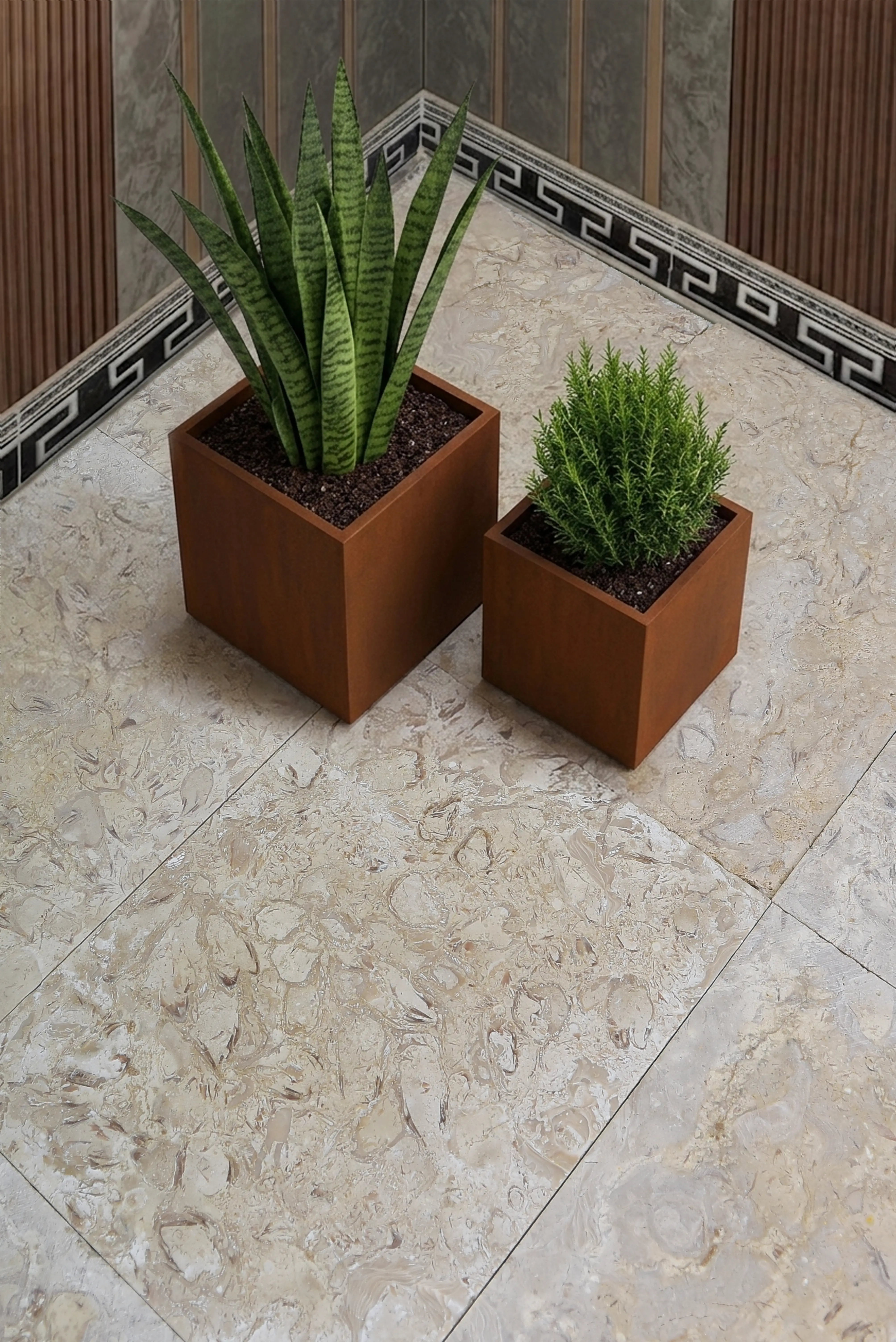 Two modern cube planters containing plants sit on a light stone floor with decorative border, pictured for granite edge profiles guide.