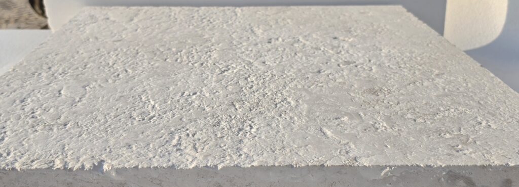 Brushed 16 grit limestone paver surface in natural light