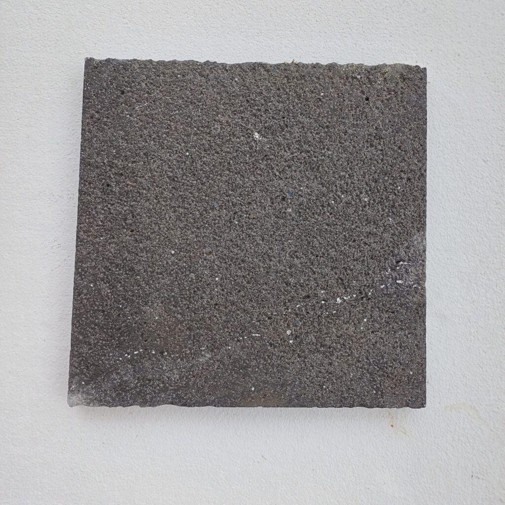 Bush-hammered black basalt tile with pocked slip-resistant surface