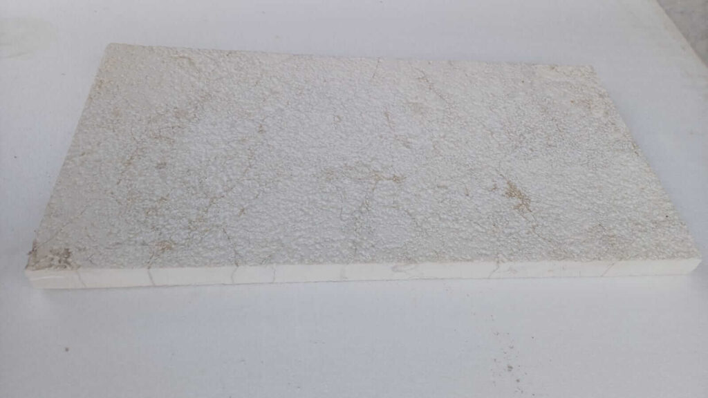 Anti-slip bush-hammered surface texture on white limestone