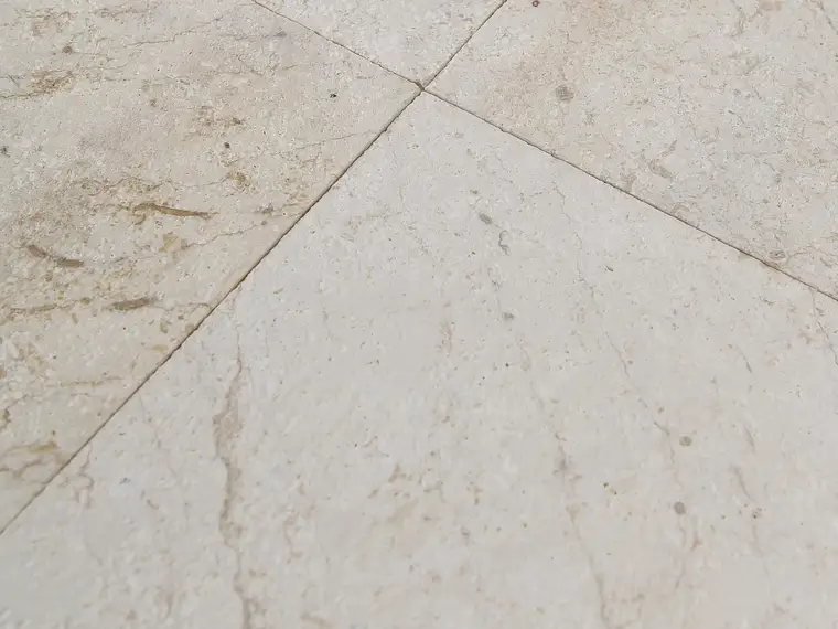 Limestone pavers dry-laid to blend natural tonal variation across crates