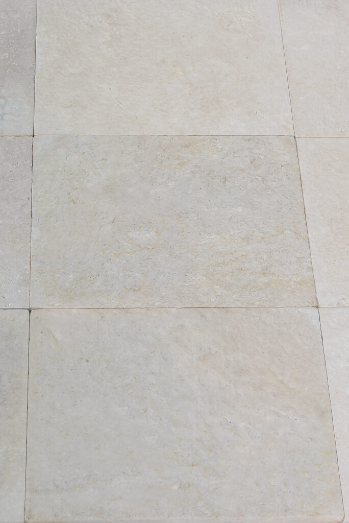 Double-brushed 24 grit limestone floor laid tight-jointed in natural light