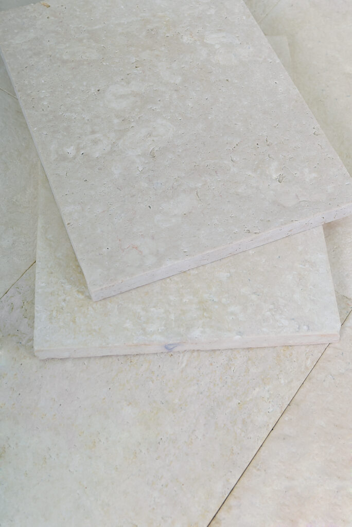 Stacked double-brushed 24 grit limestone tiles showing thickness and rounded face
