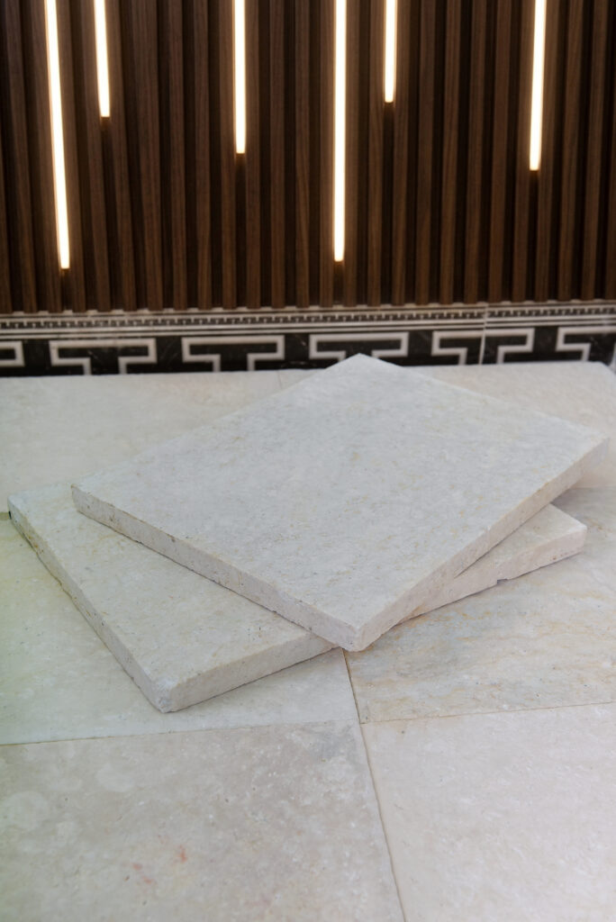 Double-brushed 60 grit limestone floor in showroom light