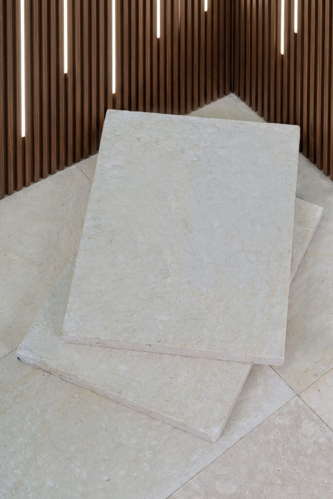 Double-brushed 60 grit limestone tile propped at an angle in the showroom