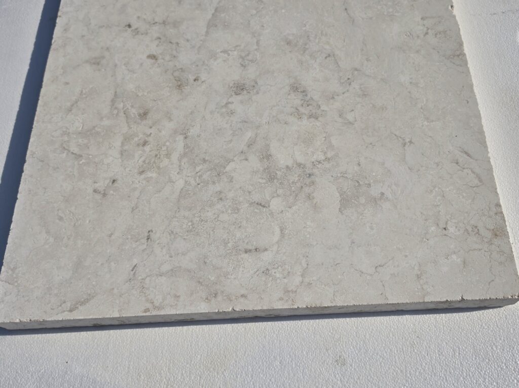 Sawn edge on 120 grit honed limestone slab