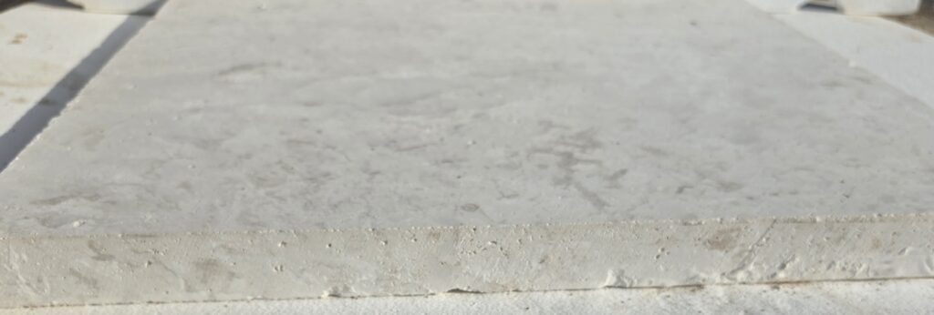 Sawn edge on 60 grit honed limestone slab