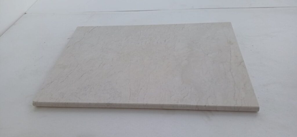 Polished white limestone tile surface in natural light