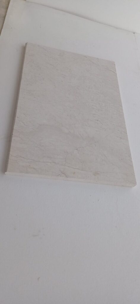Polished white limestone tile at an angle
