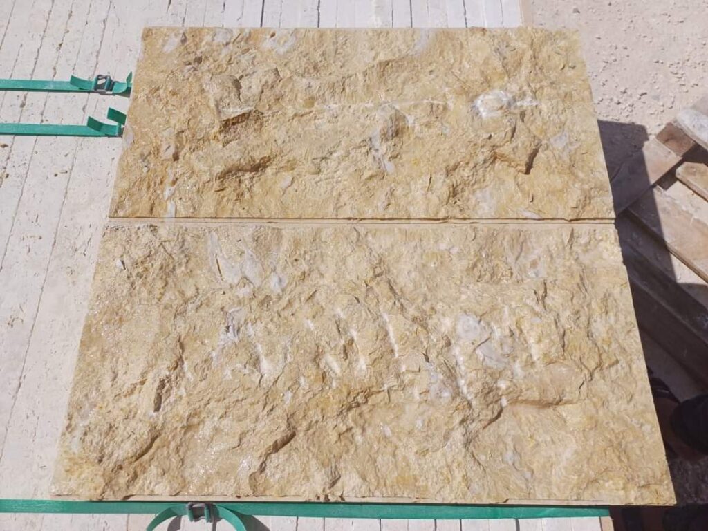 Two gold-toned split-face stone slabs banded at the factory