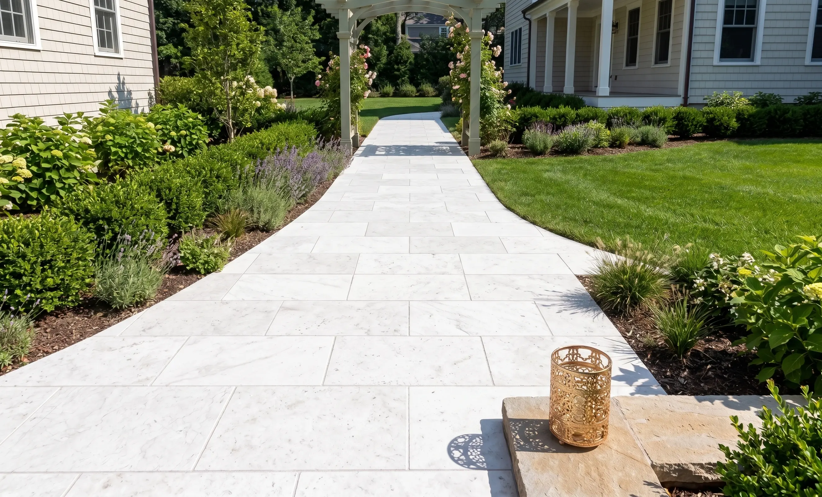 White Stone Path and Garden A curved white marble pathway leads through a manicured garden with lush greenery, an example for marble pavers cost.