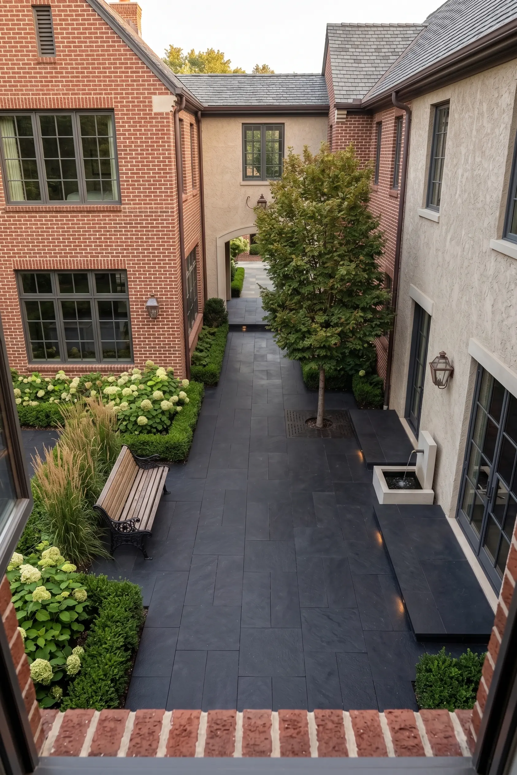 Crushed black basalt pavers create a modern walkway surrounded by lush landscaping.