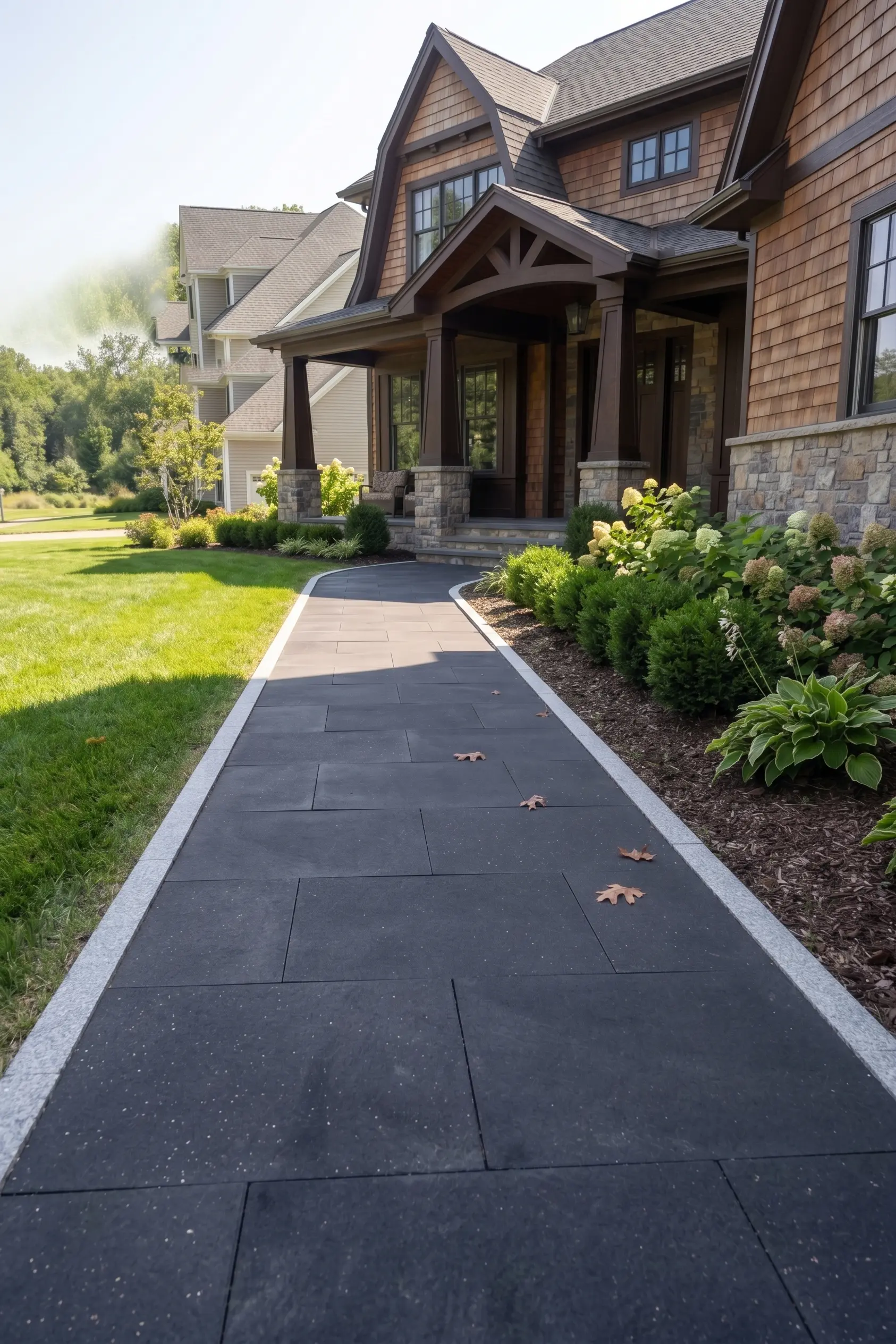 Dark basalt stone tiles with a basalt border along a landscaped path.