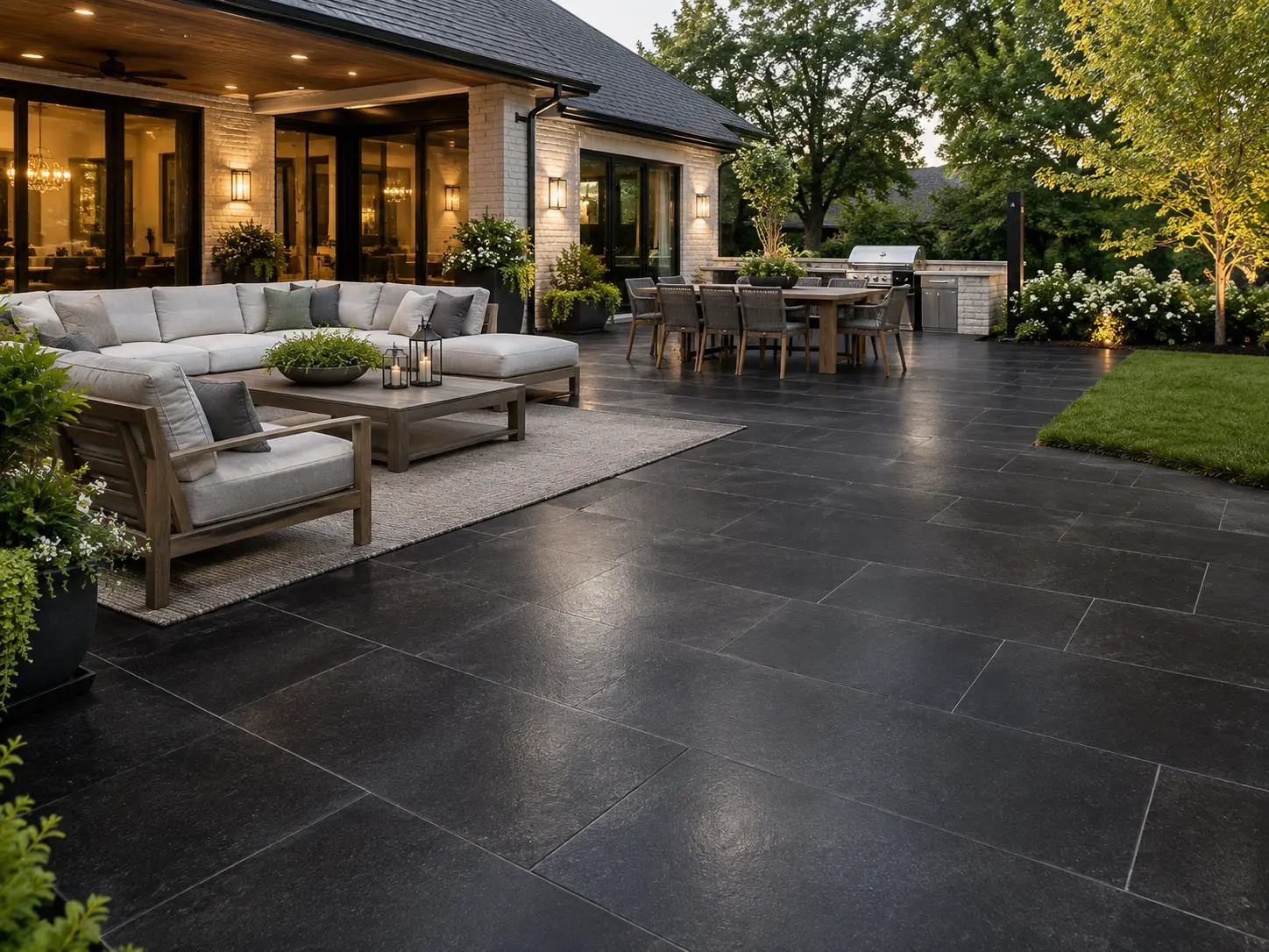 Dark Stone Patio with Outdoor Furniture Expansive dark basalt hexagon tile patio with outdoor seating and dining areas.