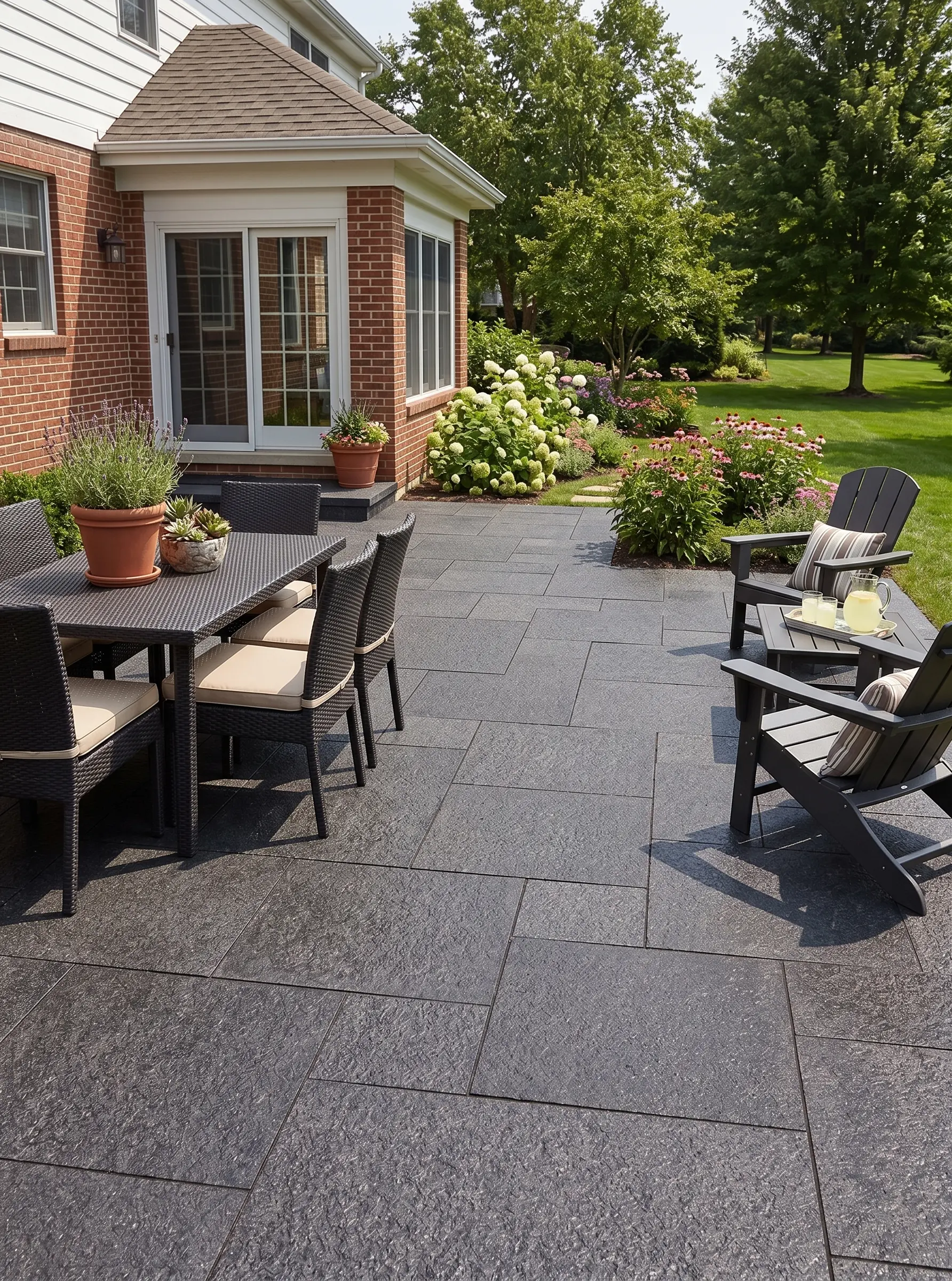 Dark, textured basalt stone patio tiles are visible in this backyard setting.