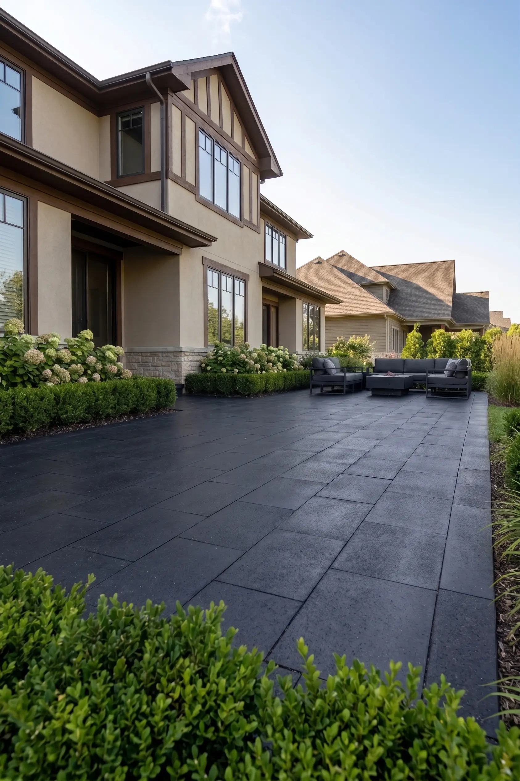 Modern Patio with Basalt Pavers Large, dark basalt pavers create a modern patio with outdoor seating.