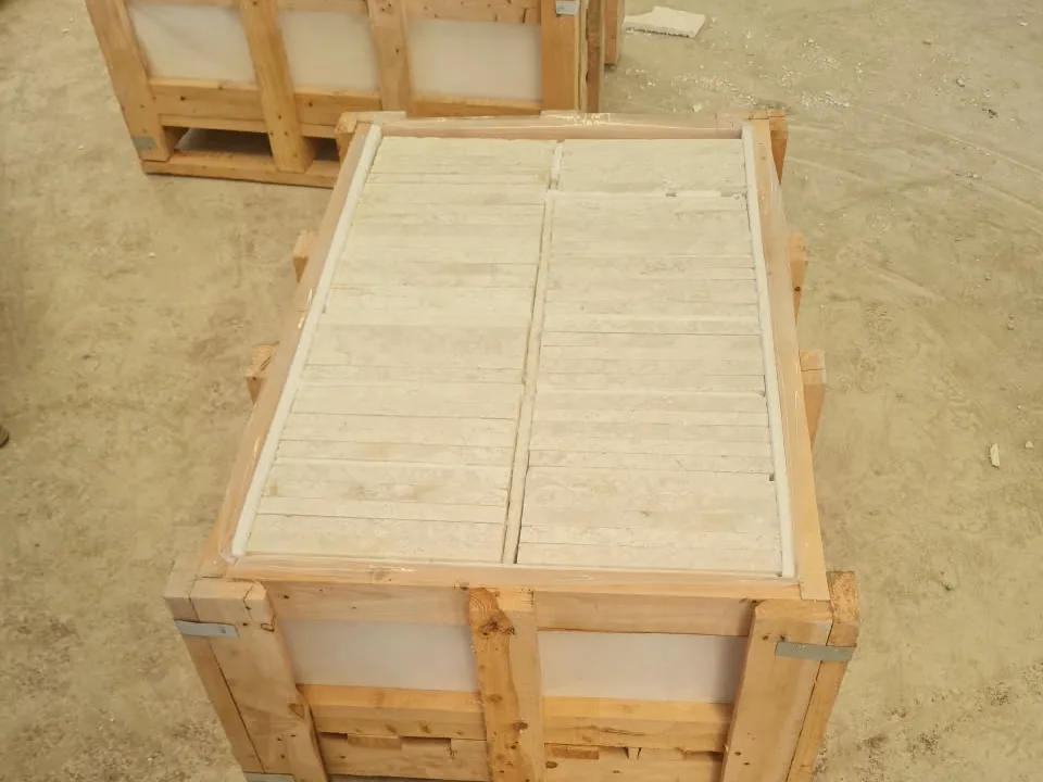 Open wooden crate packed tight with rows of pale stone pavers.