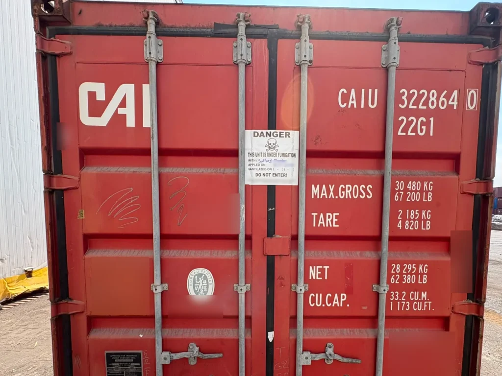 Closed red container CAIU 322864 0 with a fumigation warning notice on the door.