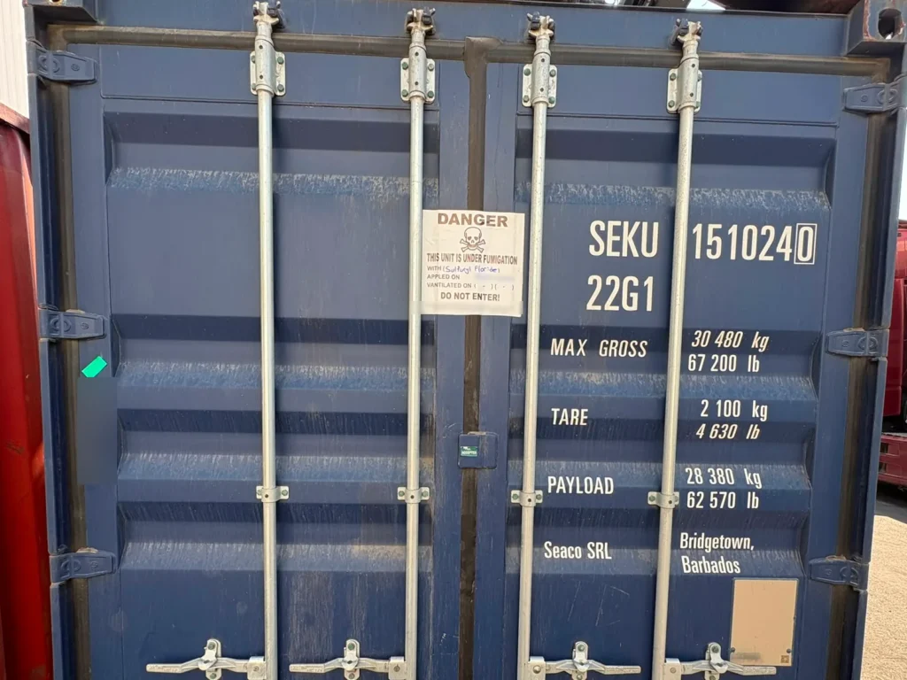 Closed blue container SEKU 151024 0 with a fumigation warning notice on the door.