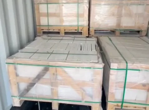 Crates of stone stacked two high inside a container.