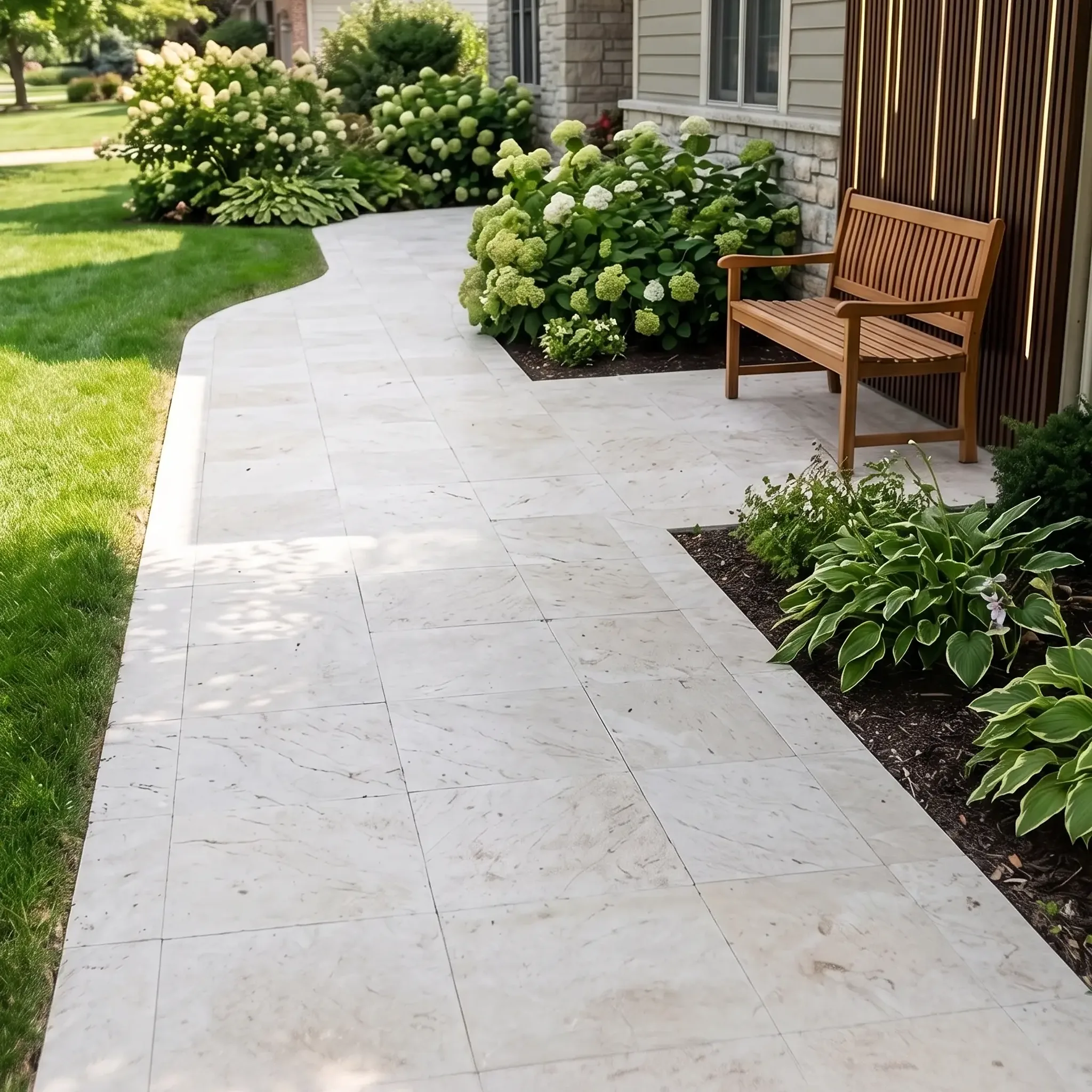 White veined marble-look pavers on a curved front walkway with teak bench, hydrangeas, hostas, lawn and a wood-slat clad…