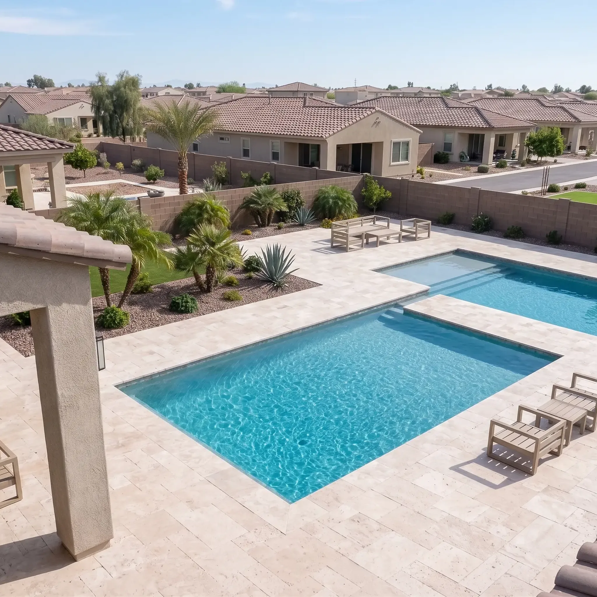 Rooftop aerial of cream limestone pavers in running bond around a pool and raised spa, wood chairs, agaves and suburban…